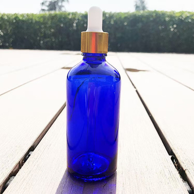 Bottle de verre vide d' huile essentielle bleue matte réutilisable et recyclable