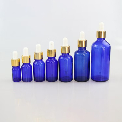 Bottle de verre vide d' huile essentielle bleue matte réutilisable et recyclable