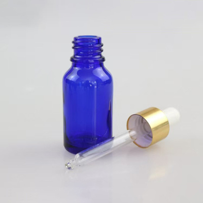 Bottle de verre vide d' huile essentielle bleue matte réutilisable et recyclable