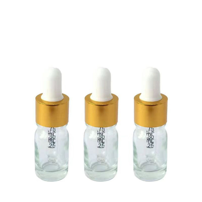 Bouteille d'huile essentielle en verre clair avec gouttelier en aluminium